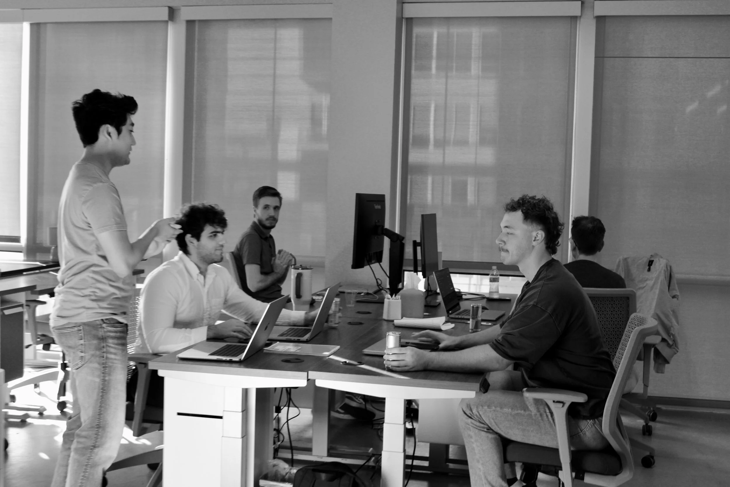 People working at shared desks in the real Foundry space before its rebrand